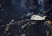 Baking flatbread on an outside wood pit.