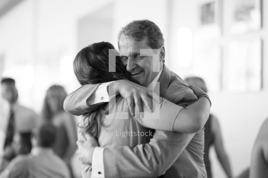 Father and daughter embracing.