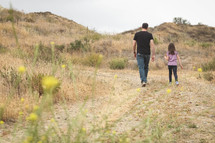 father and daughter exploring a desert landscape 