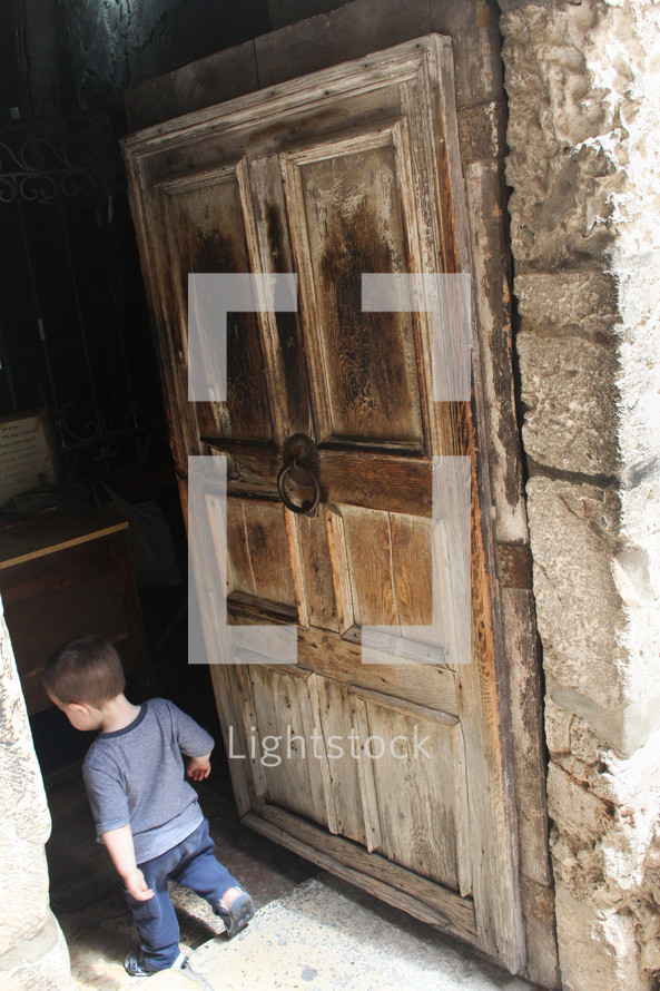 a boy entering an ancient doorway
