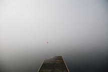 Misty view from a wooden pier.