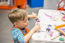 a boy child painting crafts 