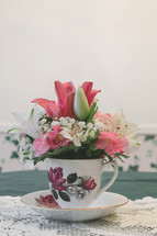 flower arrangement in a tea cup 