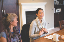 Asian women sitting at a table at a Bible study 