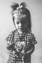 Girl holding a bouquet of roses.