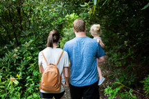 a family hiking on a forest path 