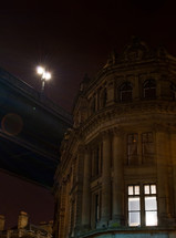 street lights on an overpass above a city townhouse