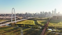 Aerial video of the Margaret Hunt Hill Bridge in downtown Dallas, Texas on a beautiful clear blue sky morning