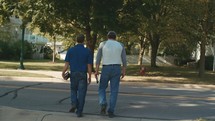 men walking carrying Bibles 