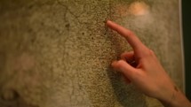 Hand of the point on a geographical old German map. Slow Motion