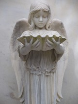 The Guardian of the eternal - An Angel statue of a chid angel holding an oyster shell adoring a grave marker. Heaven, Angels eternity.