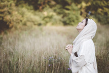 woman of biblical times kneeling in prayer 