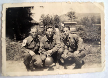 A vintage photograph of three US Army Soldiers including an Army Medic and his two pals stationed over in Normandy, France during World War II around 1942- 1944.  