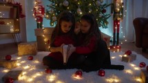 Little girls playing with a magic book 