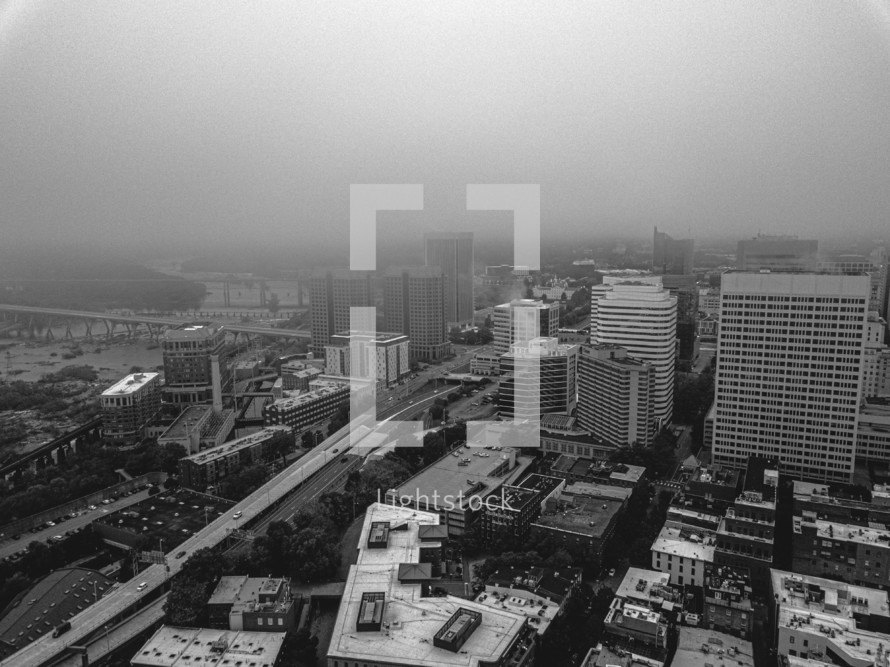 aerial view over a foggy city in black and white 