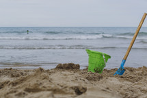 shovel and sand bucket on a beach 