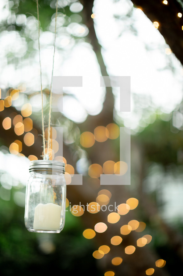 bokeh lights and a candle in a mason jar 