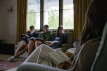 close up of young woman holding open her Bible in a small group study