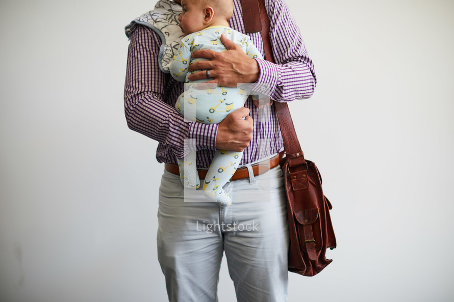 working dad holding a baby 