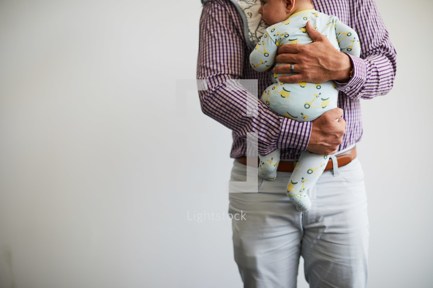 a father holding an infant 