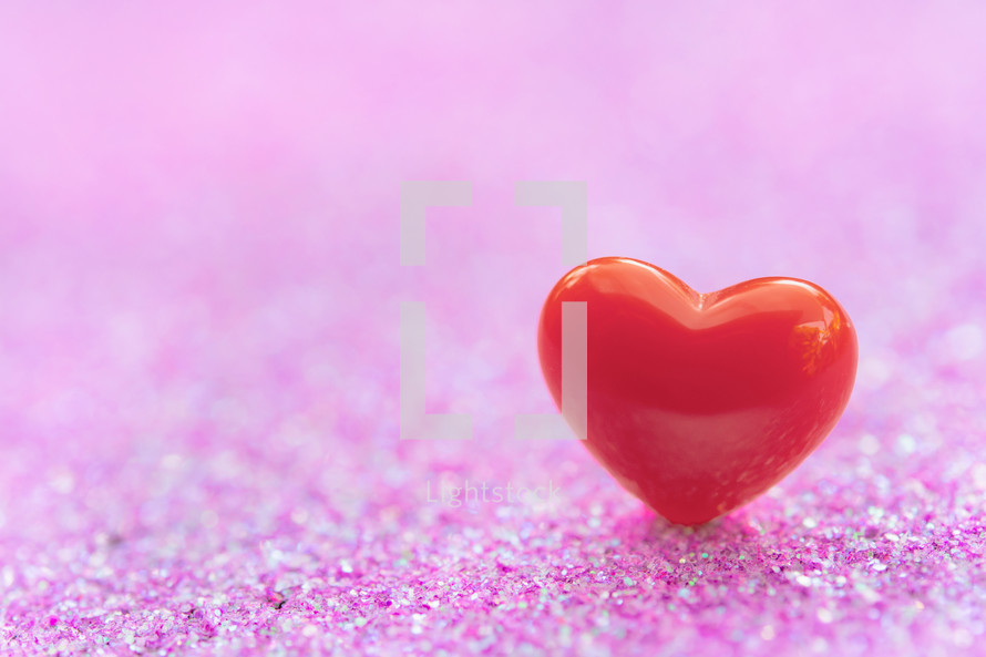 single red heart on a pink background 
