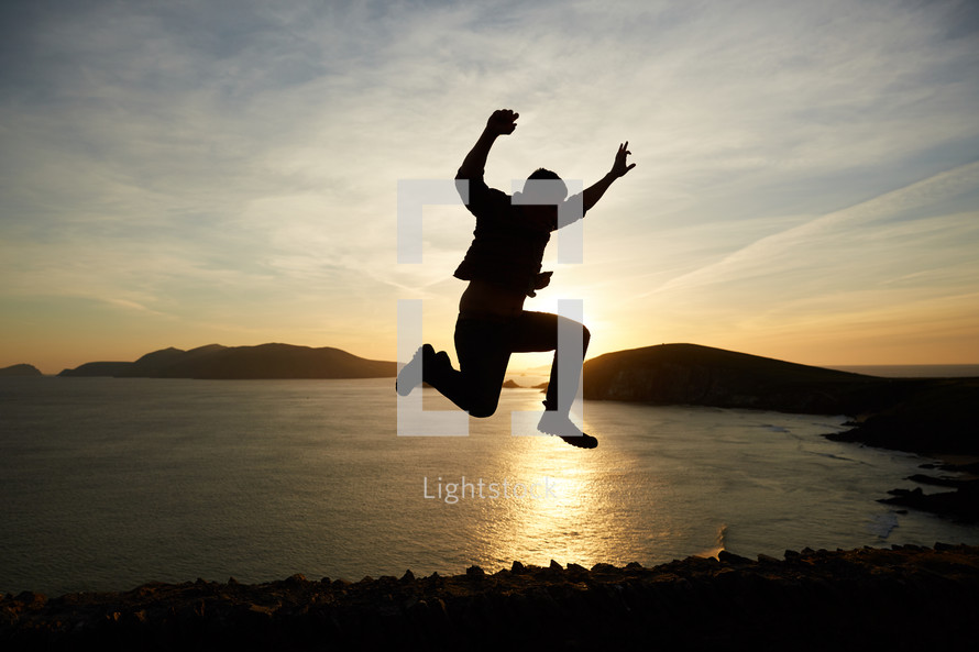 silhouette of a man jumping at sunset 
