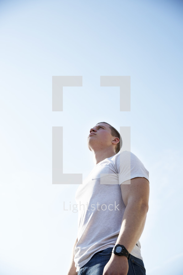 A young man looking skyward.