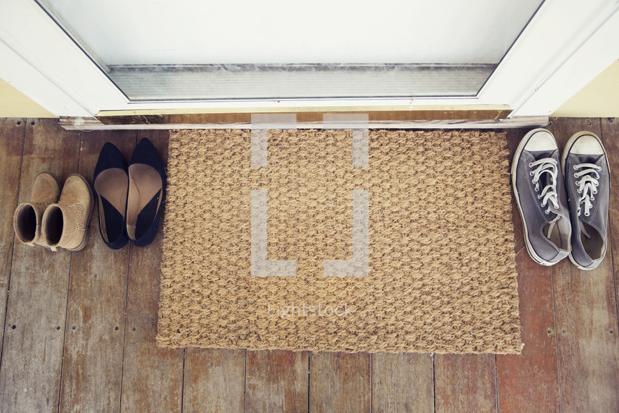 shoes by a doormat 