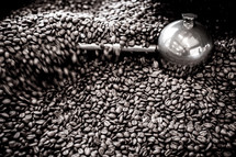 Coffee beans being roasted in a small local roastery and coffee shop