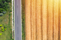 Farm land aerial view from above near country road, drone view landscape