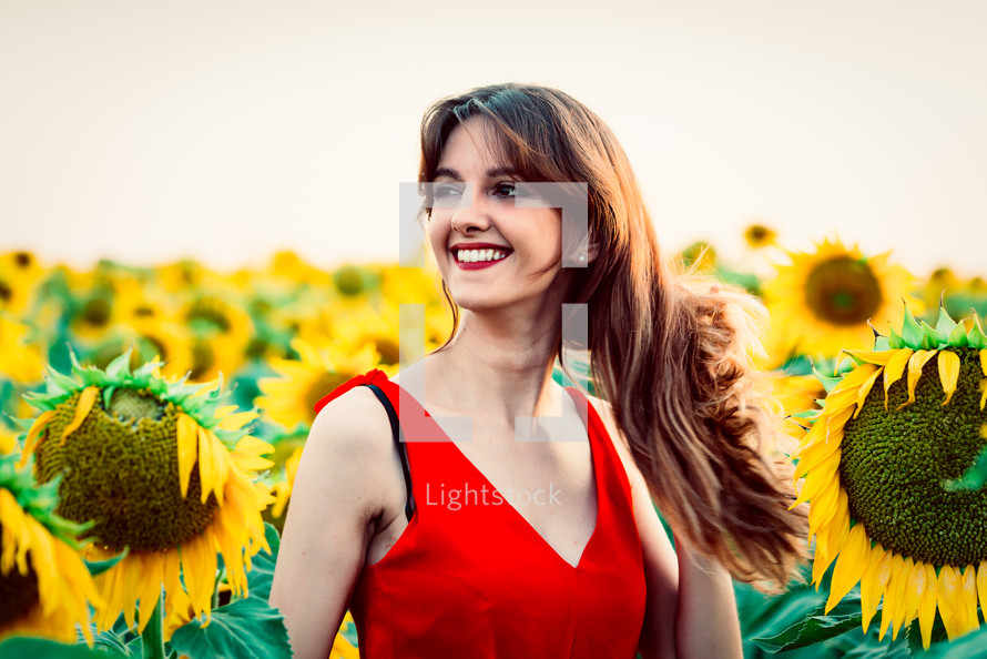 young woman in field of sunflowers.