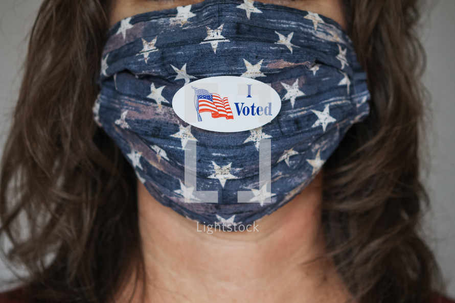 woman with an I voted sticker wearing a face mask 