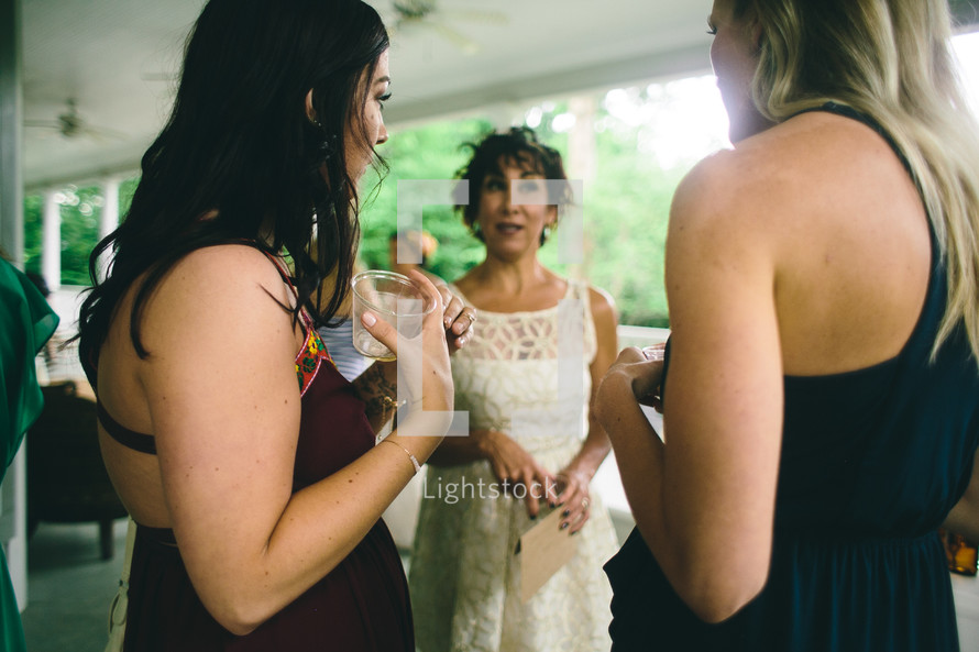 Three women dressed up at a wedding.