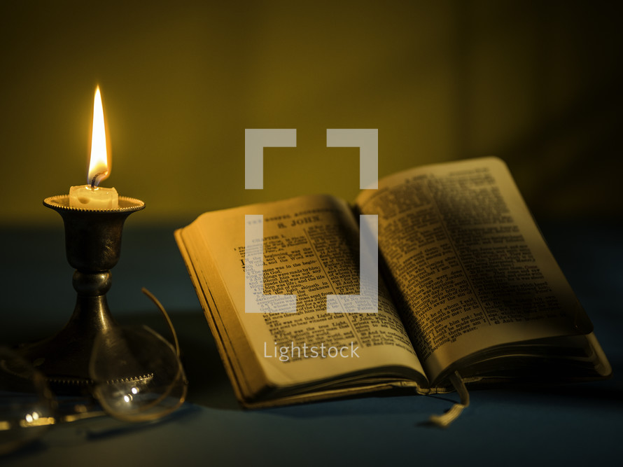 candlestick and open Bible 