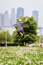 boy jumping and view of Chicago 