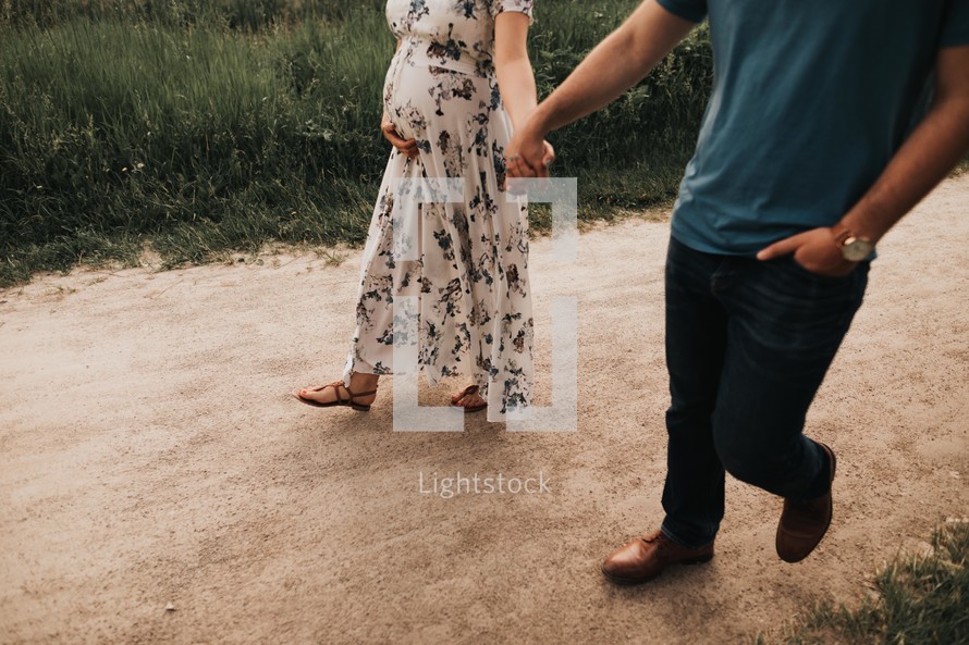 expecting couple on a walk 