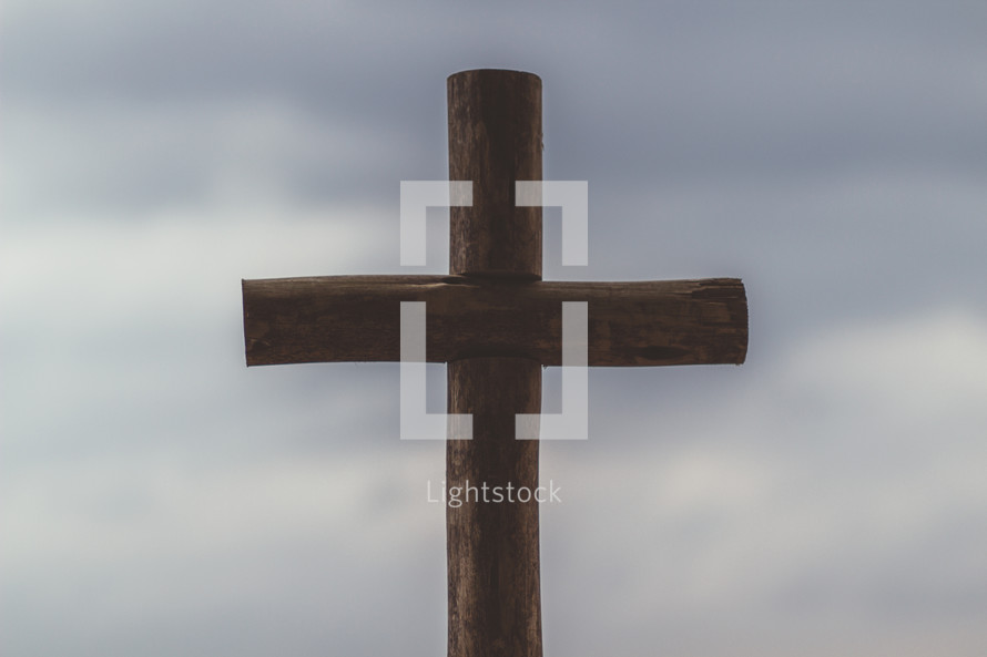 silhouette of a cross and cloudy sky