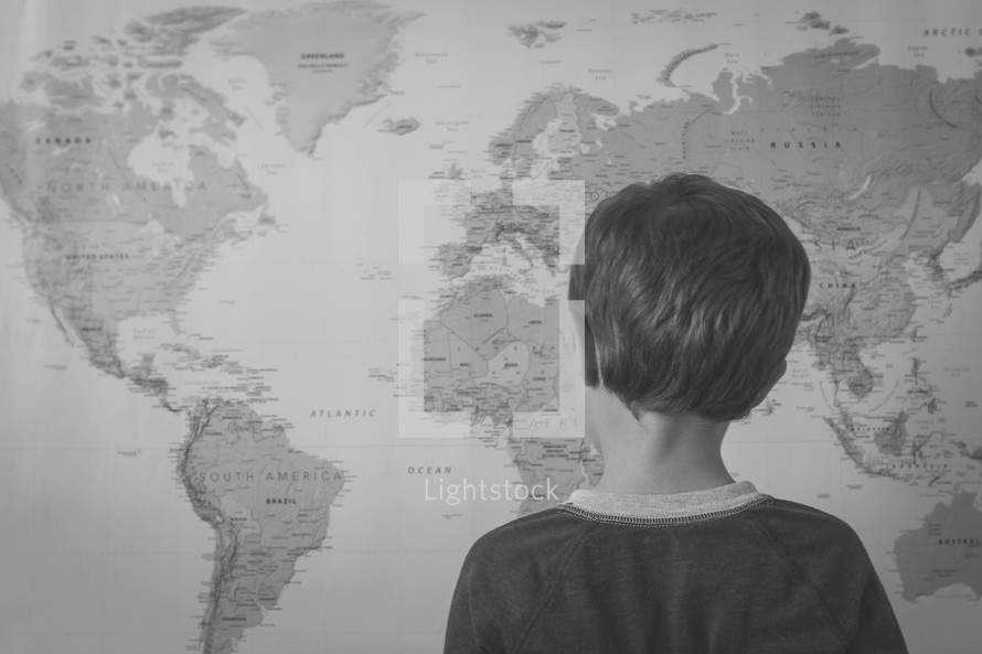 world map and child looking at it 