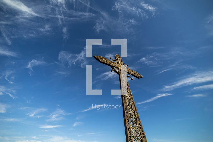 church cross on sky background with clouds.