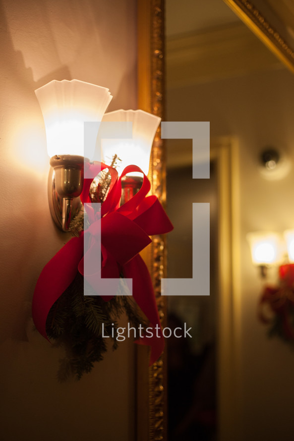 red bow Christmas swag on wall lamps