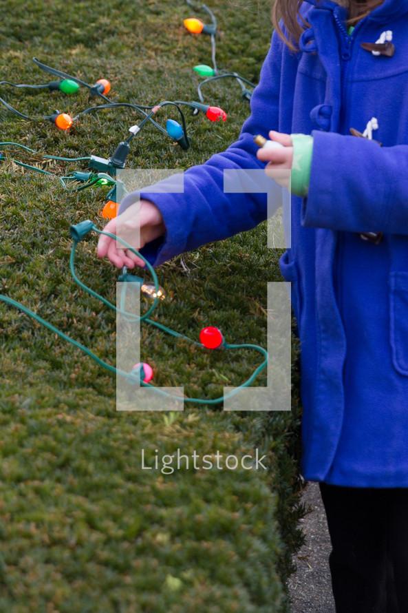 putting up Christmas lights outdoors 