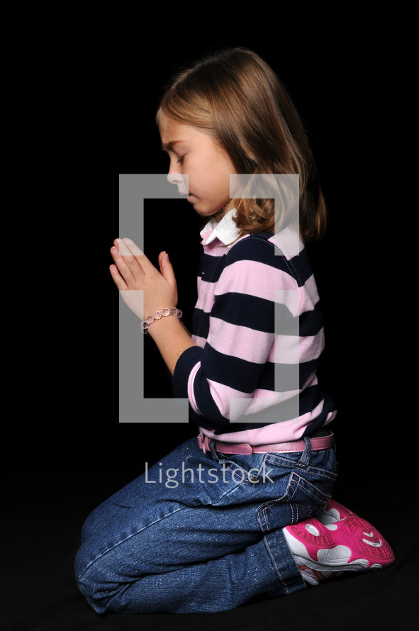 girl child kneeling in prayer 