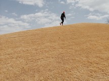 man running up a steep hill 