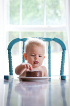toddler boy eating birthday cake 