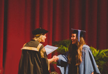 woman receiving her diploma at graduation 
