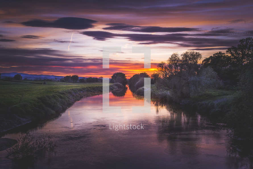 a still river at sunset 