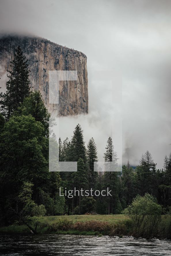 thick clouds over a steep cliffs and river scene 