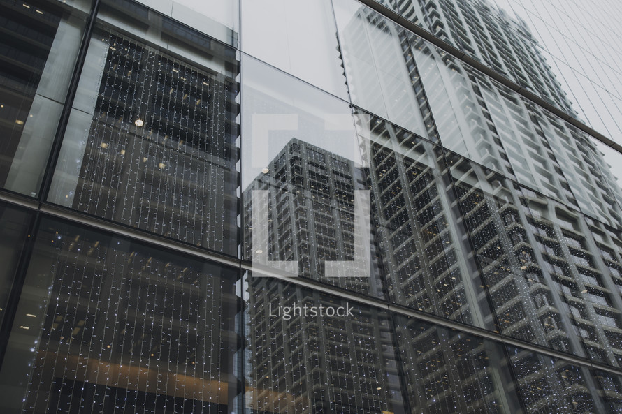 reflection of city buildings on window glass 