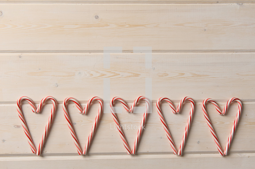 row of candy canes in the shape of hearts 