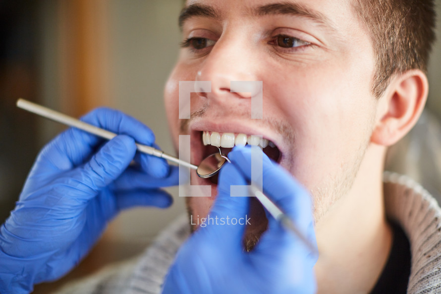 a dentist looking at a patient's teeth 